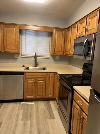 a kitchen with stainless steel appliances granite countertop a sink stove and microwave