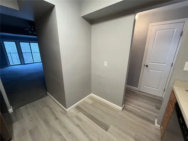 a view of hallway with wooden floor
