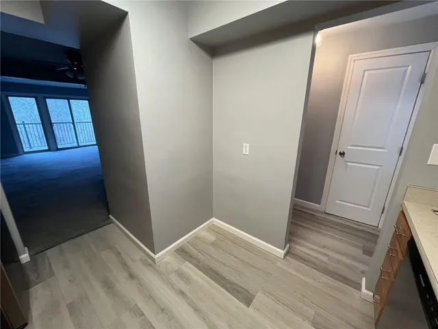 a view of hallway with wooden floor
