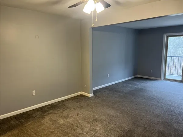 an empty room with a chandelier fan