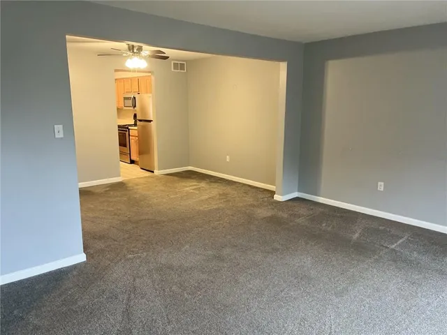 an empty room with closet and a fireplace