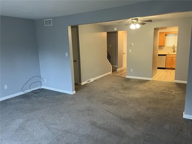 an empty room with windows and closet
