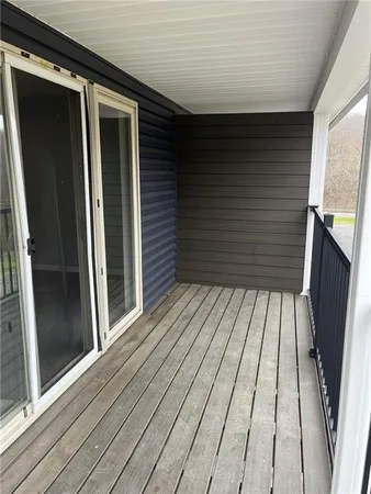 a view of balcony with wooden floor