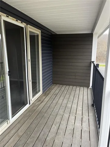 a view of balcony with wooden floor
