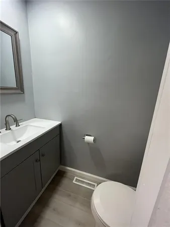 a bathroom with a sink vanity and mirror