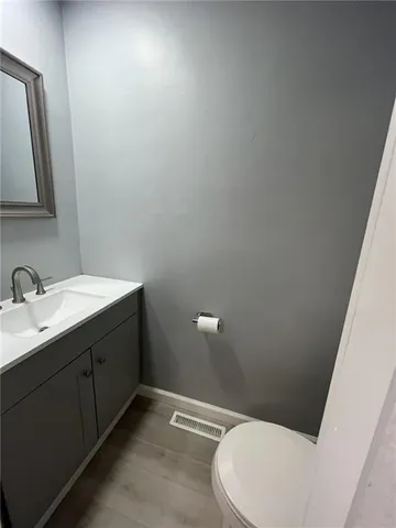 a bathroom with a sink vanity and mirror