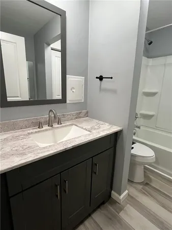 a bathroom with a toilet and a bathtub