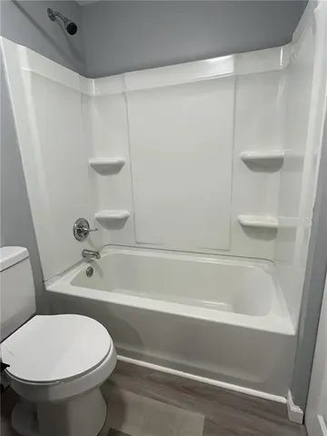 a bathroom with a bathtub and a toilet