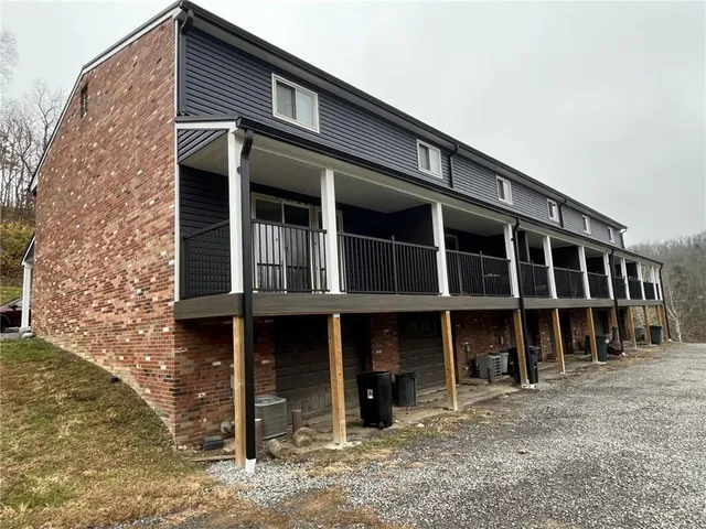 a view of a house with a yard and balcony