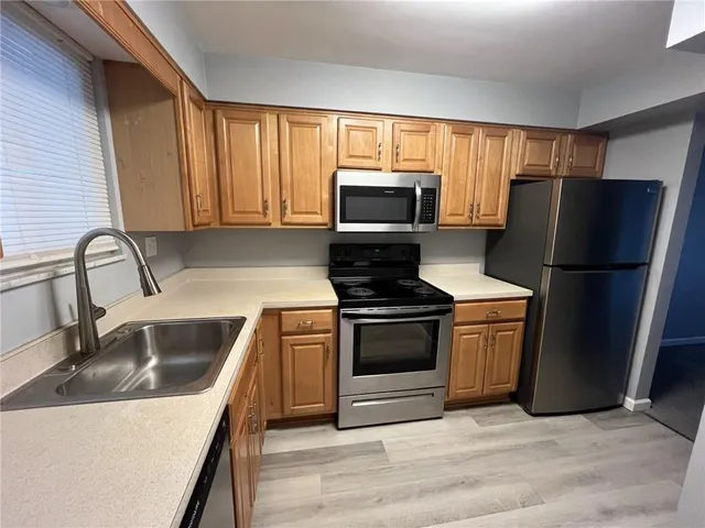 a kitchen with a refrigerator sink and microwave