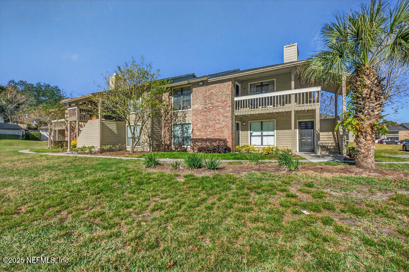 10200 Belle Rive Boulevard, Unit 105 Jacksonville, FL 32256 - Photo 1 of 47 a front view of a house with a yard
