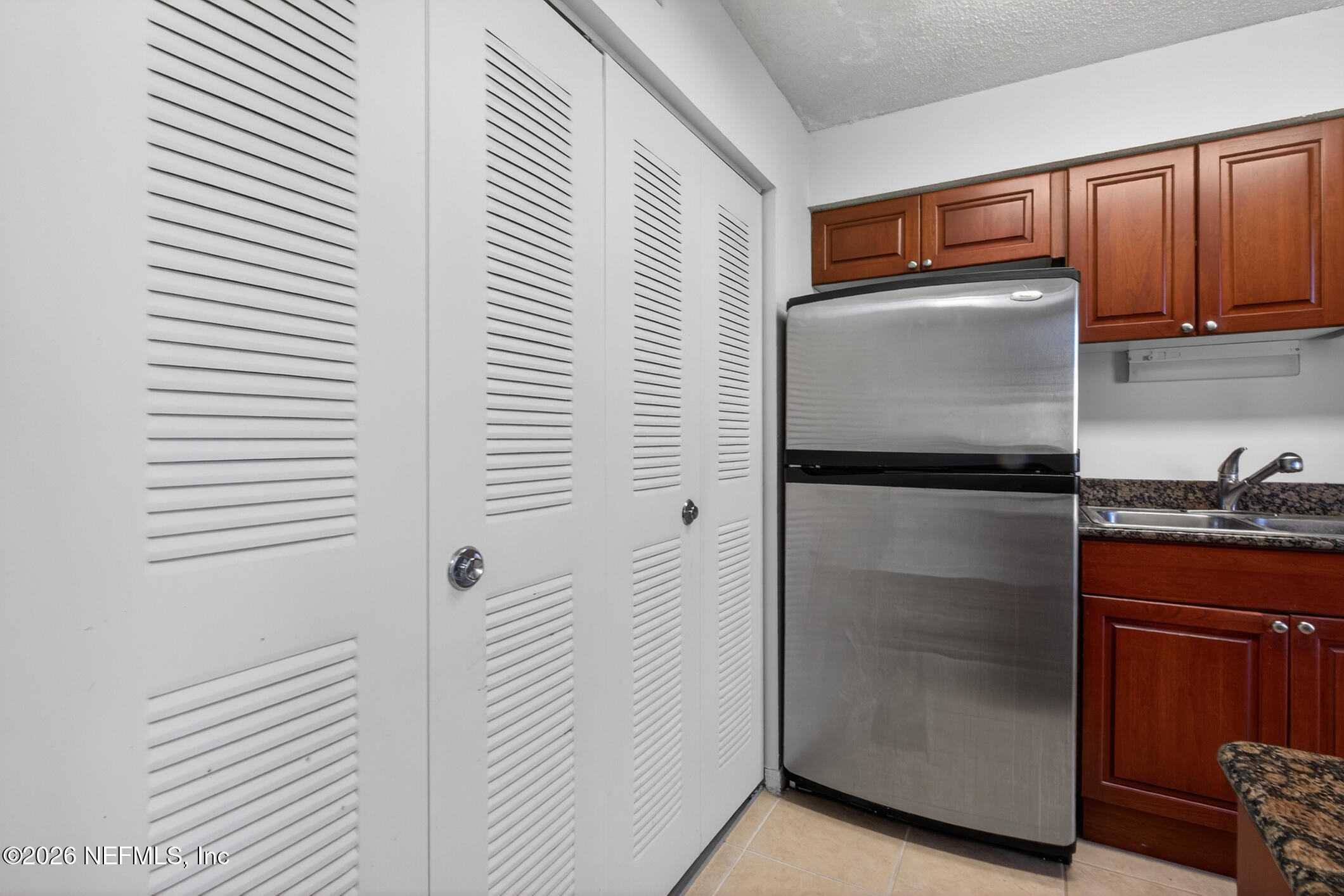 10200 Belle Rive Boulevard, Unit 105 Jacksonville, FL 32256 - Photo 16 of 47 a kitchen with stainless steel appliances granite countertop a refrigerator and a sink