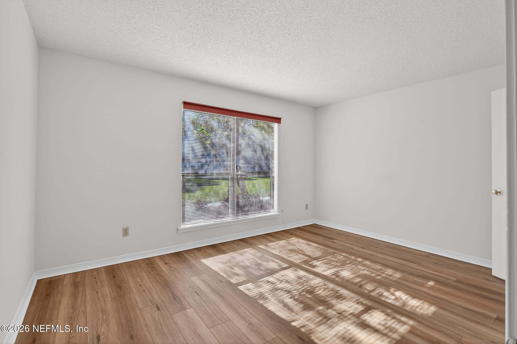 10200 Belle Rive Boulevard, Unit 105 Jacksonville, FL 32256 - Photo 22 of 47 wooden floor in an empty room with a window