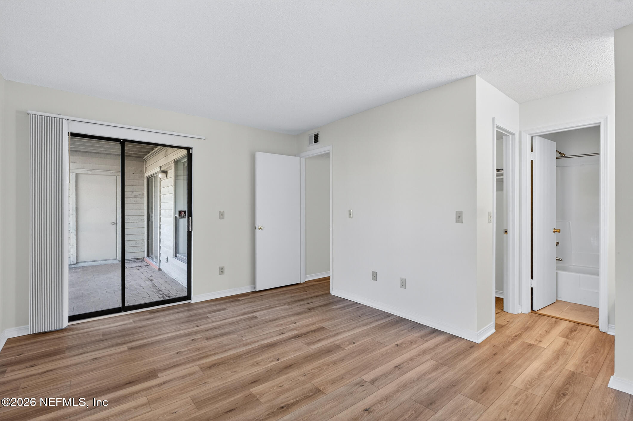10200 Belle Rive Boulevard, Unit 105 Jacksonville, FL 32256 - Photo 29 of 47 a view of an empty room with wooden floor and closet