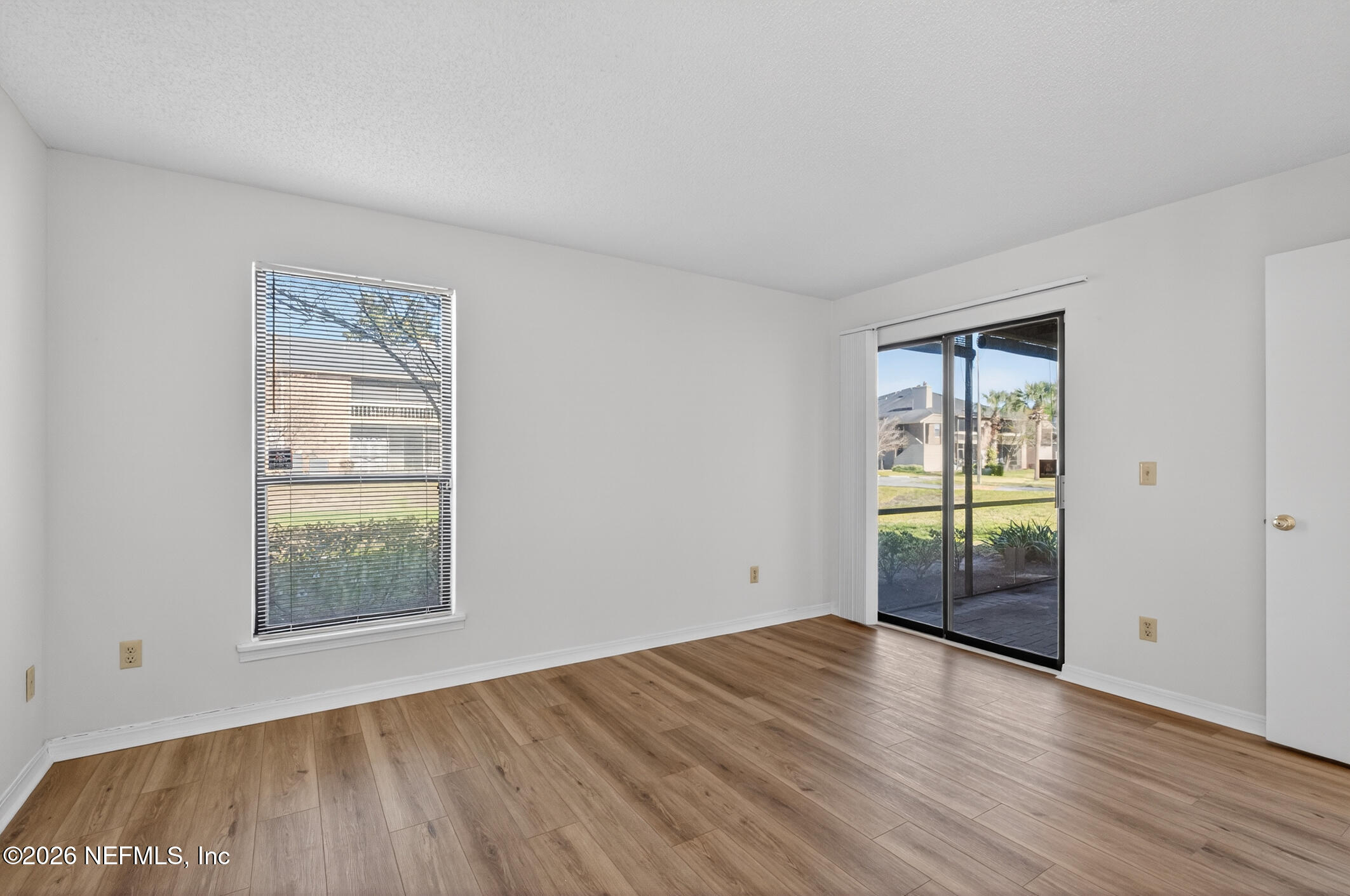 10200 Belle Rive Boulevard, Unit 105 Jacksonville, FL 32256 - Photo 31 of 47 an empty room with wooden floor and windows