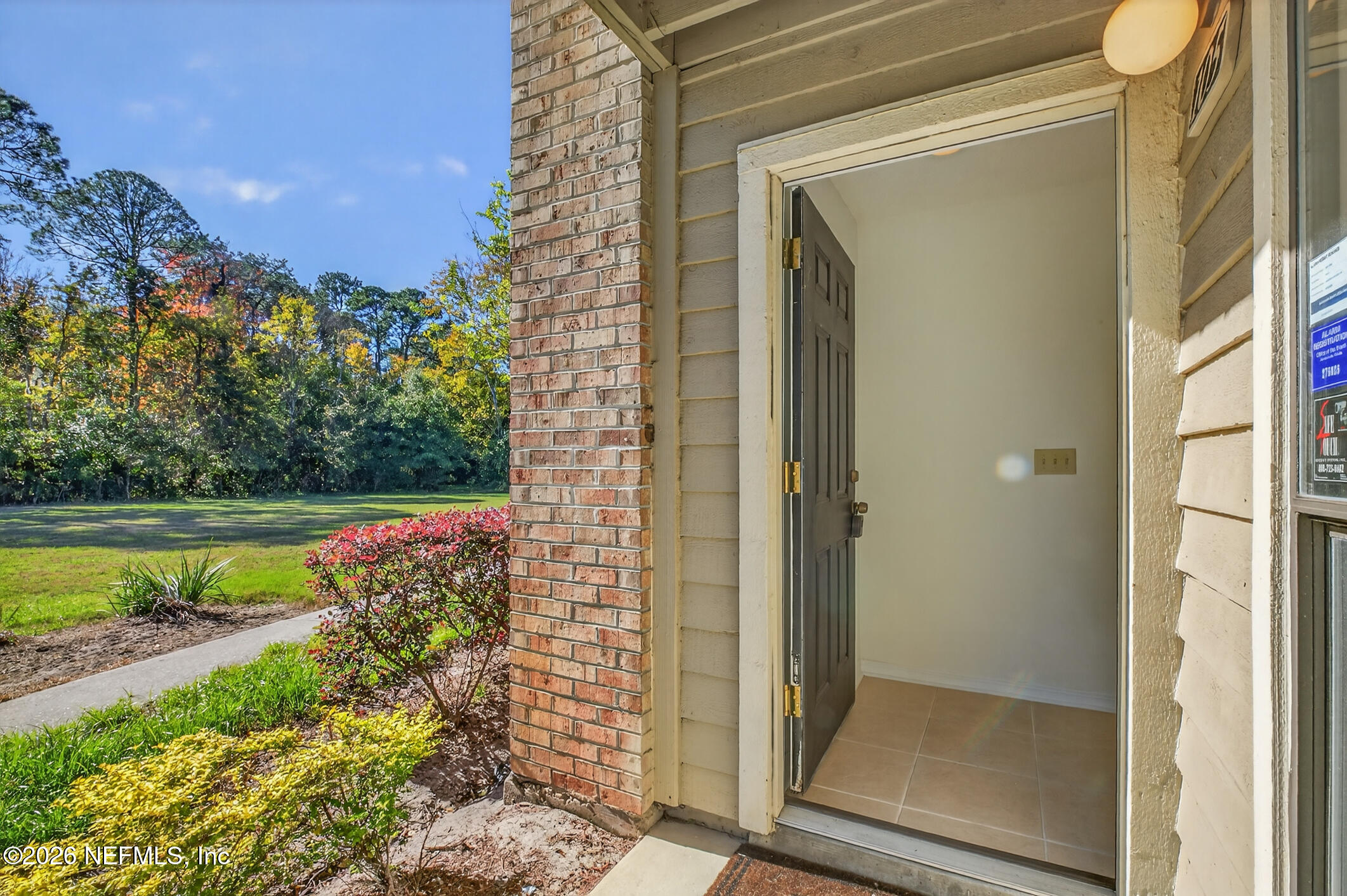 10200 Belle Rive Boulevard, Unit 105 Jacksonville, FL 32256 - Photo 5 of 47 a view of a balcony with a floor to ceiling window and yard