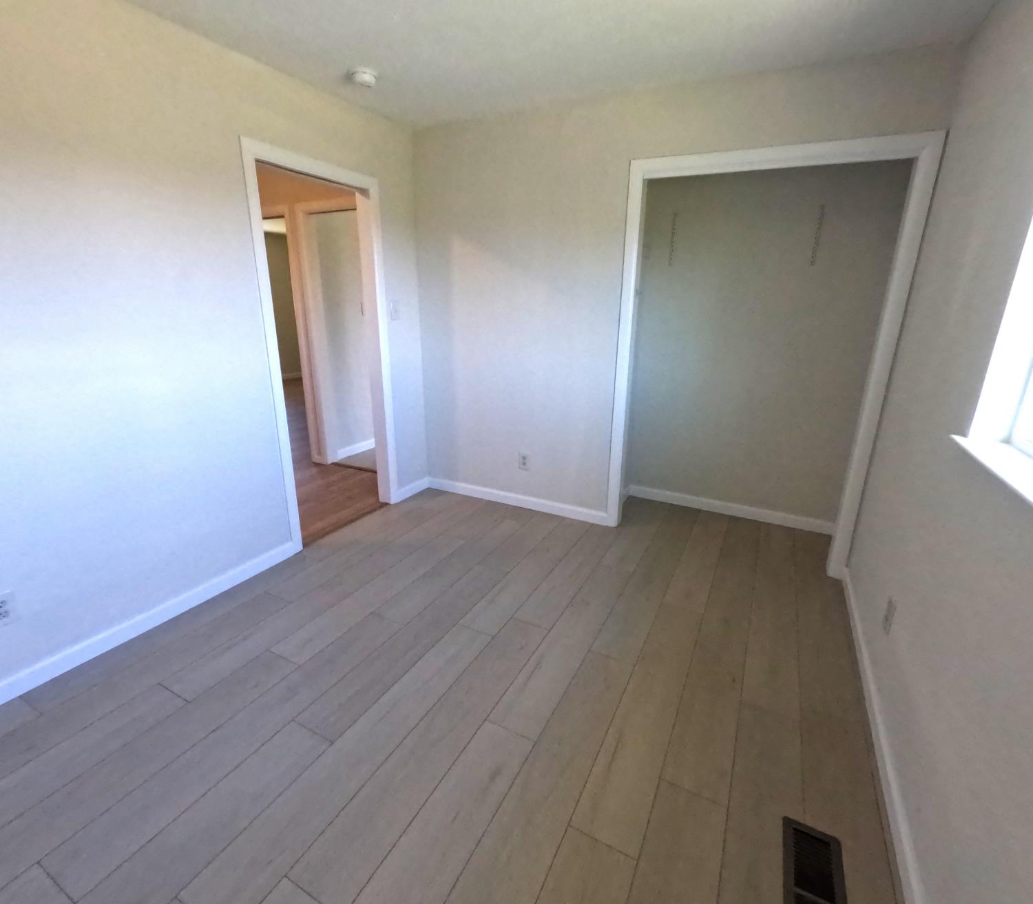 21665 Manton School Road Manton, CA 96059 - Photo 17 of 30 an empty room with wooden floor and mirror