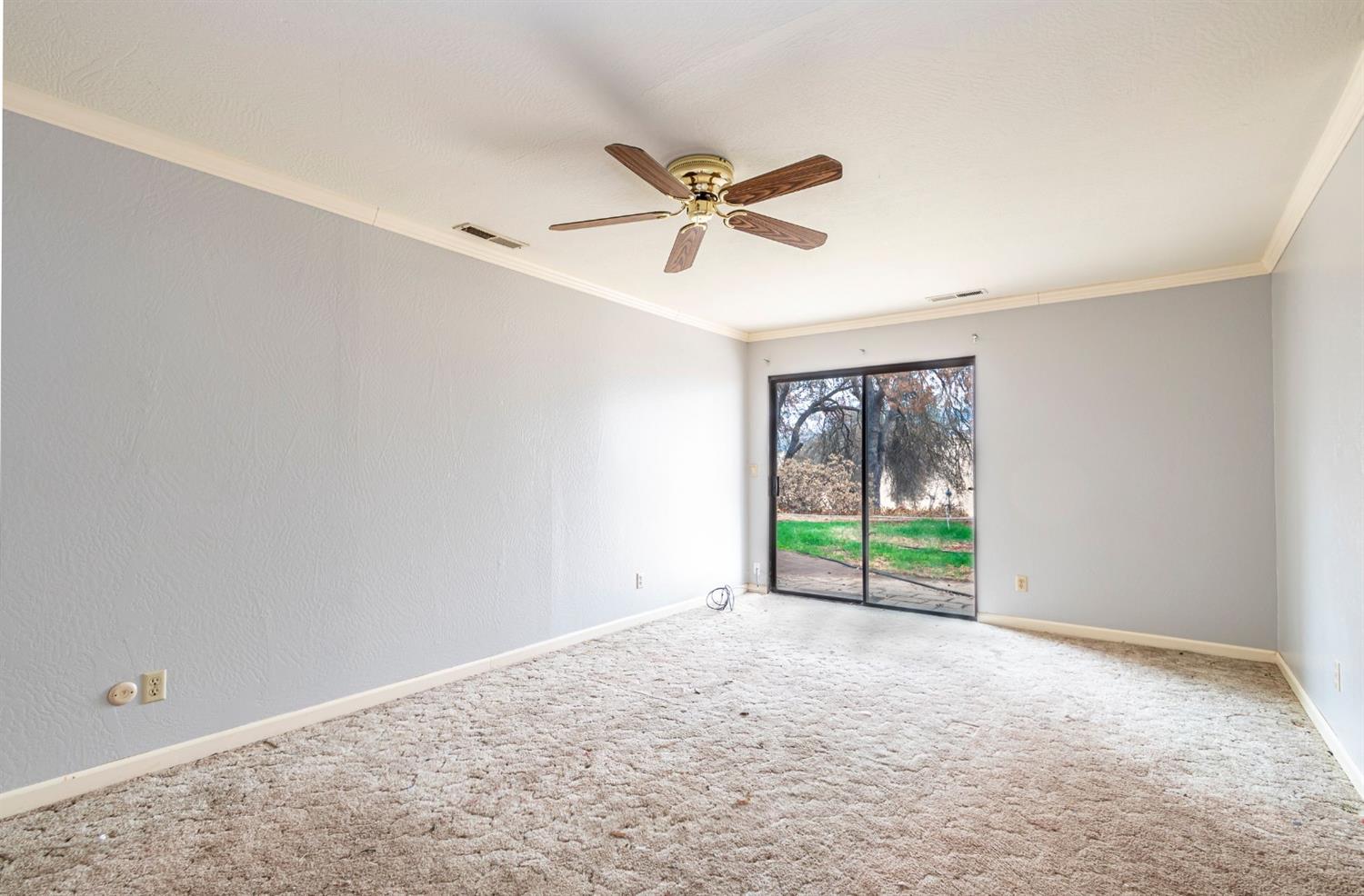 22235 Frontier Road Clovis, CA 93619 - Photo 13 of 31 Master bedroom with sliding glass door to back yard and patio.