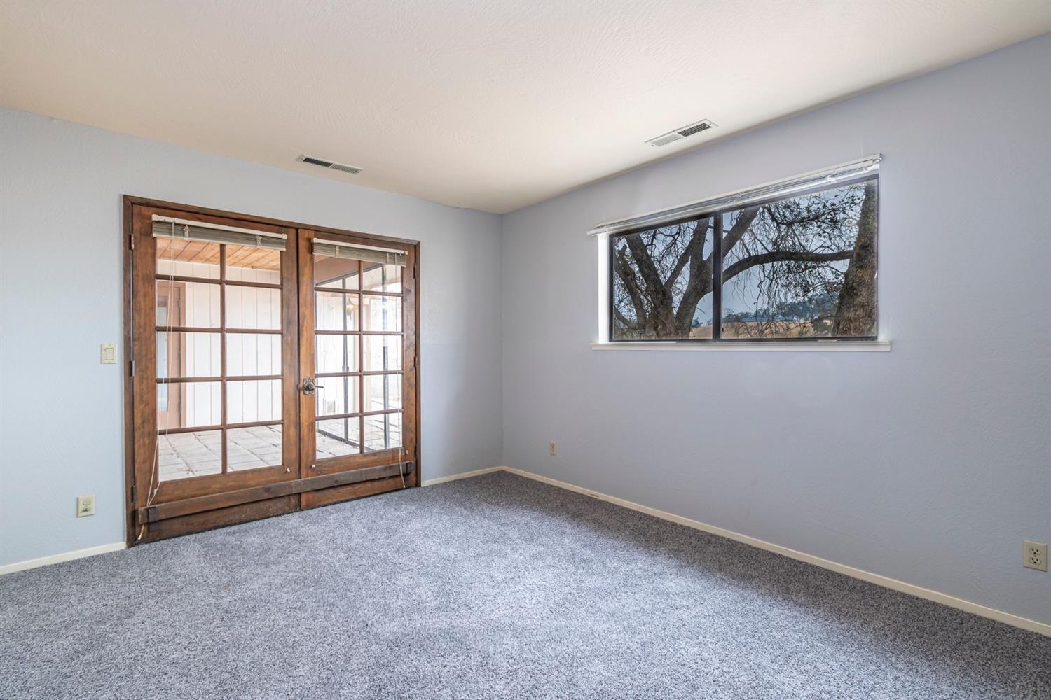 22235 Frontier Road Clovis, CA 93619 - Photo 20 of 31 Second bedroom with double doors to screened in patio.