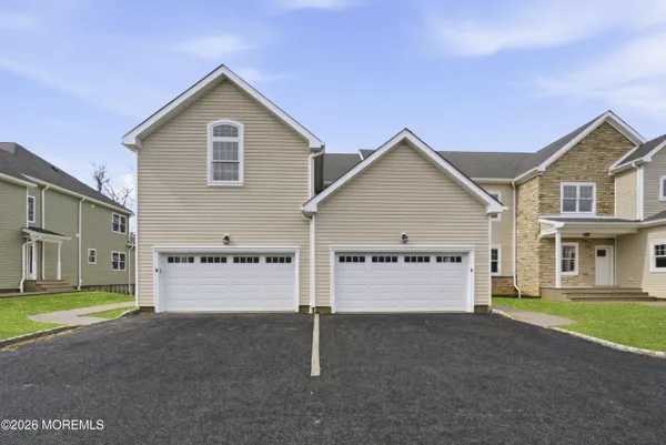 a view of a big house with a big yard and garage