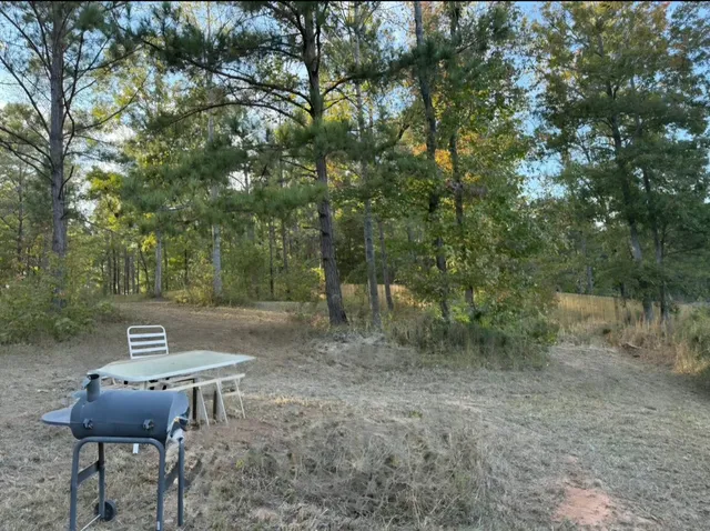 a backyard of a house with table and chairs