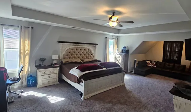 a bedroom with a bed and a chandelier