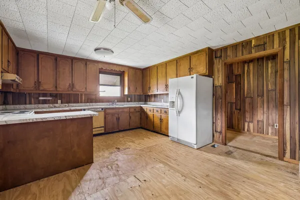 a kitchen with a refrigerator a sink and cabinets