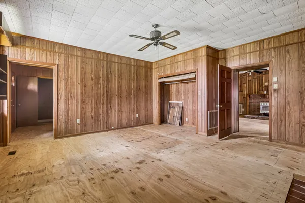 a view of an empty room with a fireplace and a window