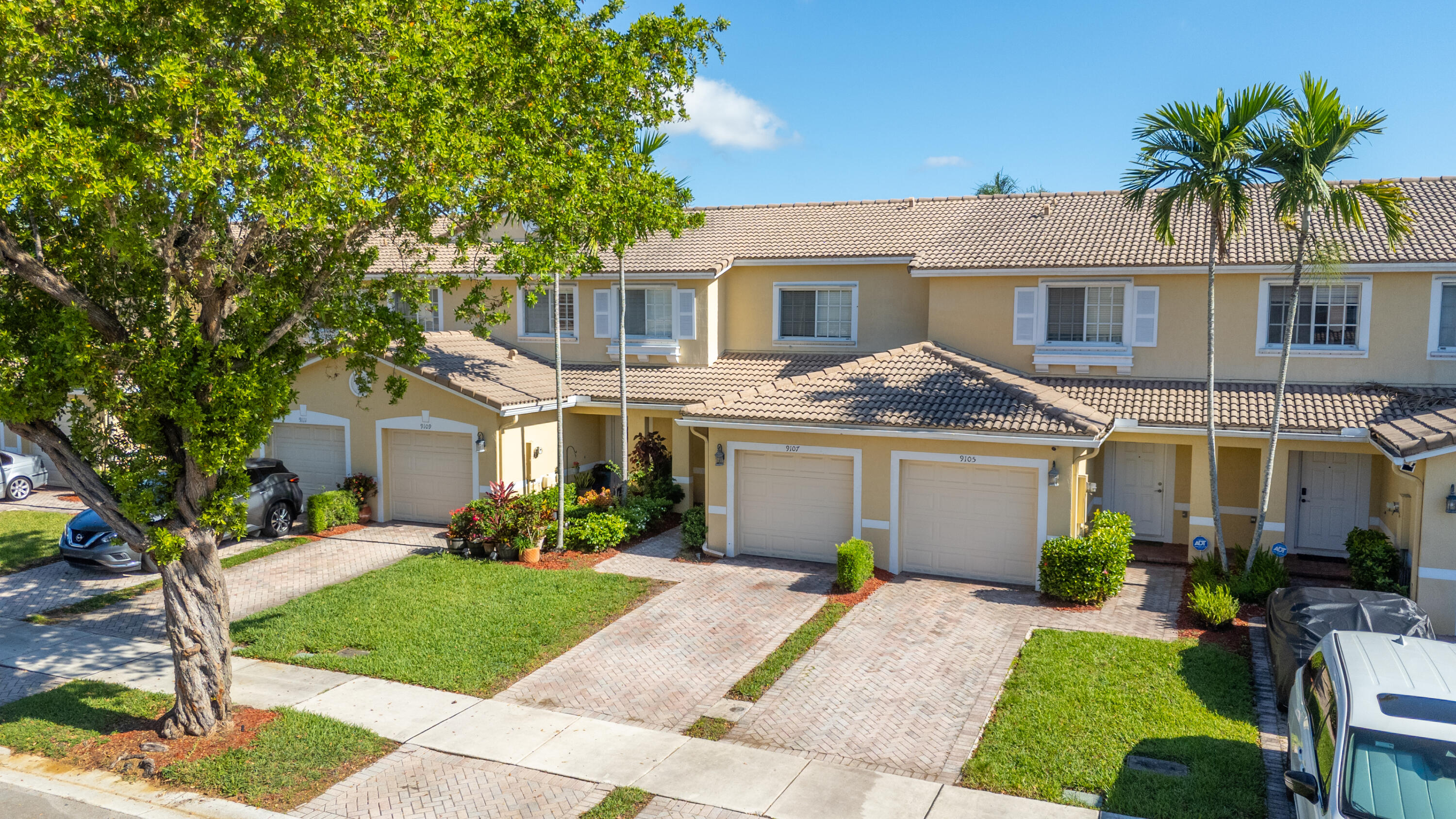 9107 Chambers Street, Unit 9107 Tamarac, FL 33321 - Photo 3 of 30 a front view of a house with a garden and yard