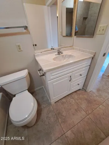 a white toilet sitting next to a bathroom sink