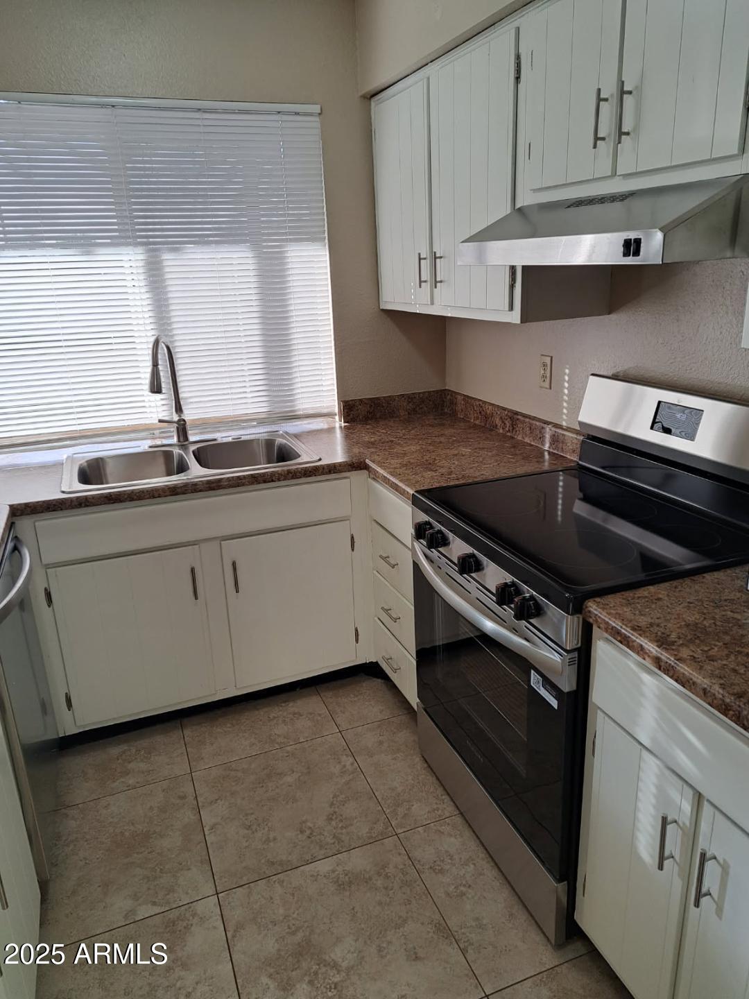 834 South Casitas Drive, Unit B Tempe, AZ 85288 - Photo 2 of 23 a kitchen with stainless steel appliances granite countertop a stove a sink and white cabinets