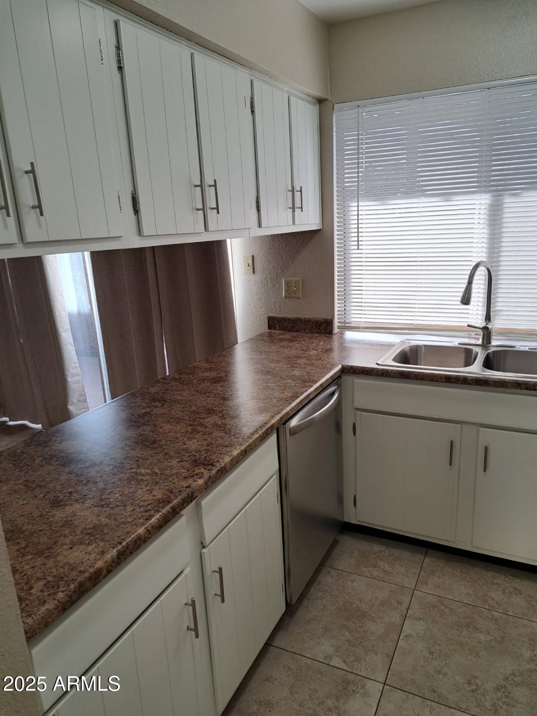 834 South Casitas Drive, Unit B Tempe, AZ 85288 - Photo 4 of 23 a kitchen with stainless steel appliances granite countertop a sink and a white cabinets