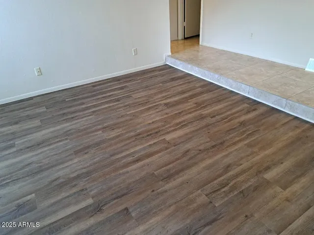 a view of a room with wooden floor