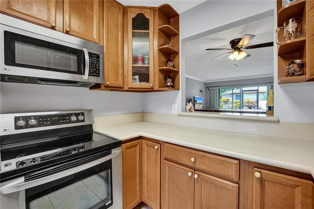 20830 Wendall Terrace, Unit 58 Boca Raton, FL 33433 - Photo 11 of 27 a kitchen with a stove and a microwave