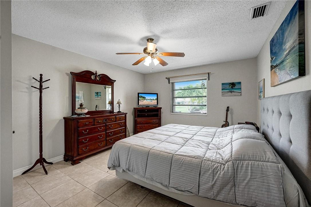 20830 Wendall Terrace, Unit 58 Boca Raton, FL 33433 - Photo 16 of 27 a bedroom with a bed and a dresser