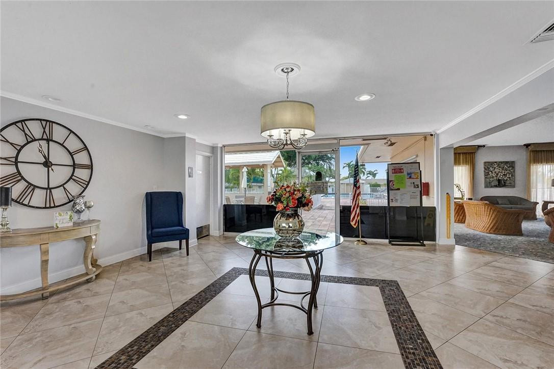 20830 Wendall Terrace, Unit 58 Boca Raton, FL 33433 - Photo 24 of 27 a living room with furniture a dining table and a fireplace