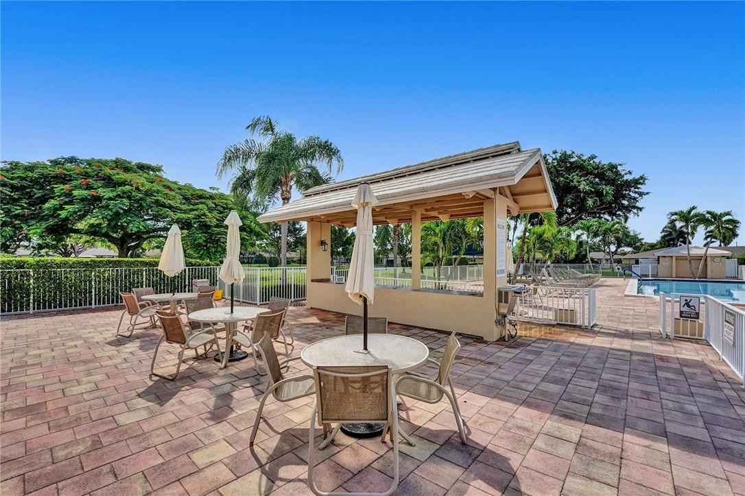 20830 Wendall Terrace, Unit 58 Boca Raton, FL 33433 - Photo 25 of 27 a view of a patio with chairs and potted plants