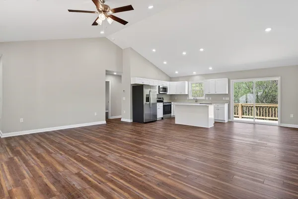 a kitchen with stainless steel appliances granite countertop a stove a sink and a refrigerator