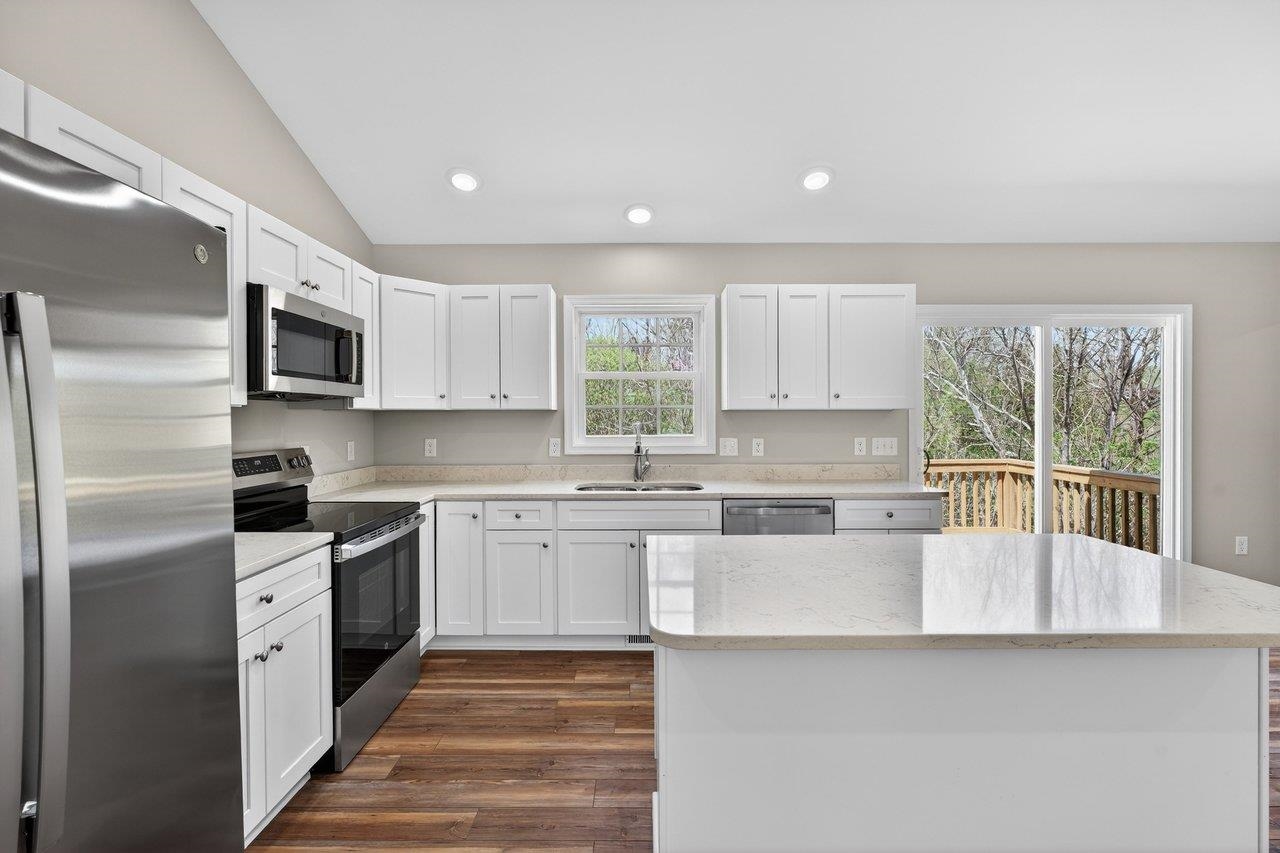 254 Locustdale Loop Shenandoah, VA 22849 - Photo 17 of 58 a kitchen with stainless steel appliances granite countertop a stove a sink and a refrigerator