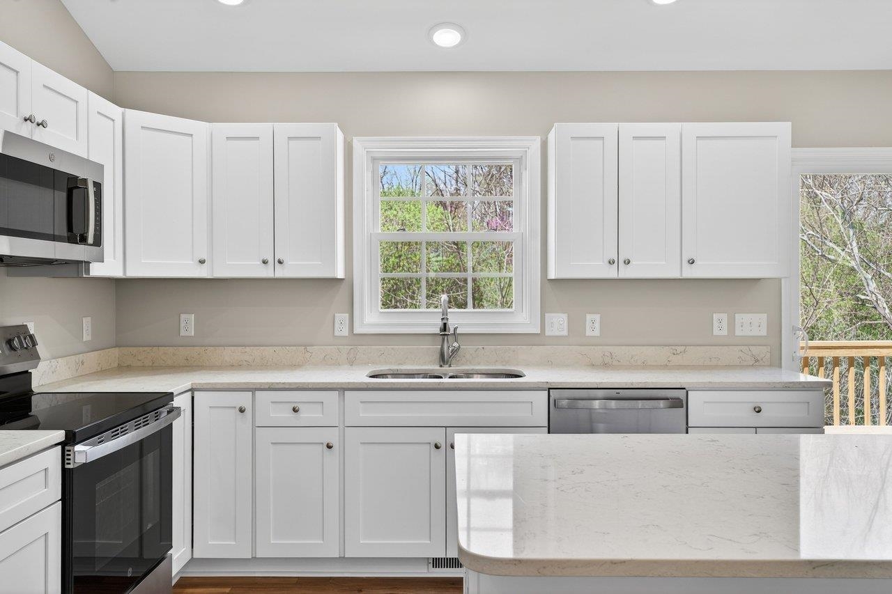 254 Locustdale Loop Shenandoah, VA 22849 - Photo 18 of 58 a kitchen with white cabinets and white appliances