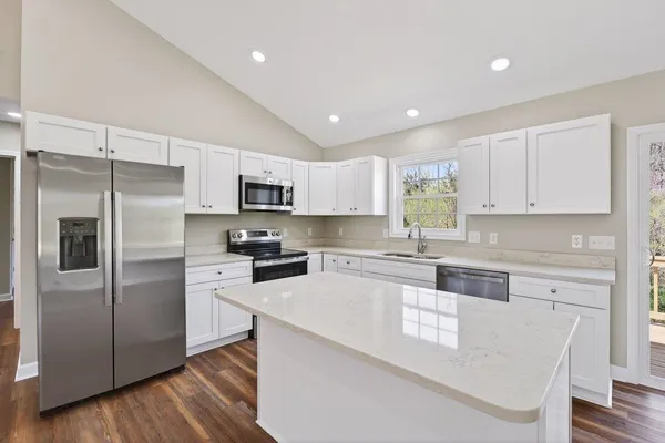 a kitchen with a sink a stove and refrigerator