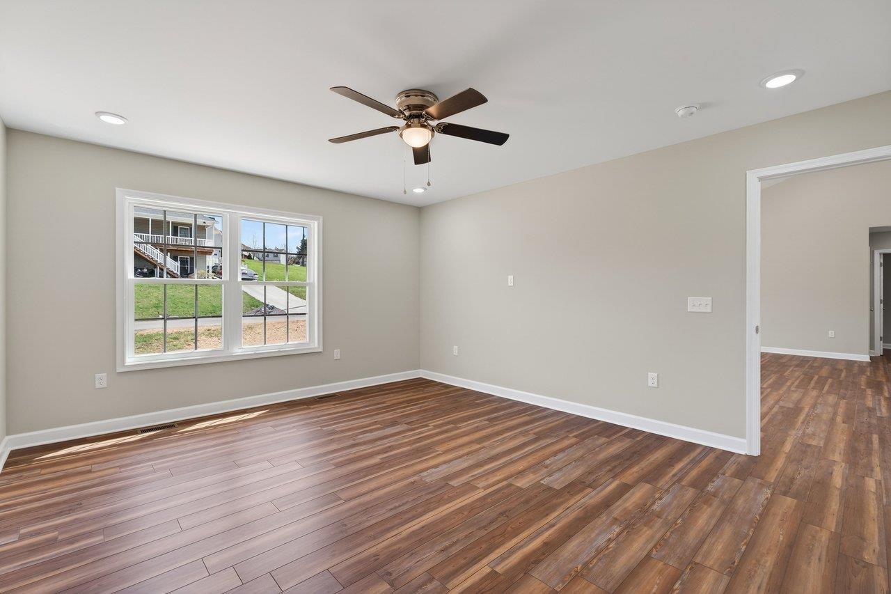 254 Locustdale Loop Shenandoah, VA 22849 - Photo 30 of 58 an empty room with wooden floor a ceiling fan and windows