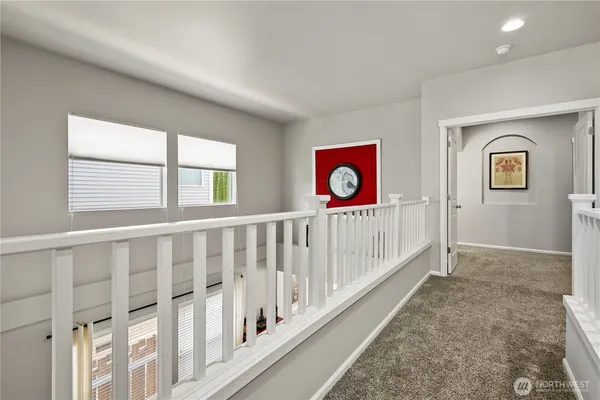a bedroom with a bed a desk and chair with wooden floor