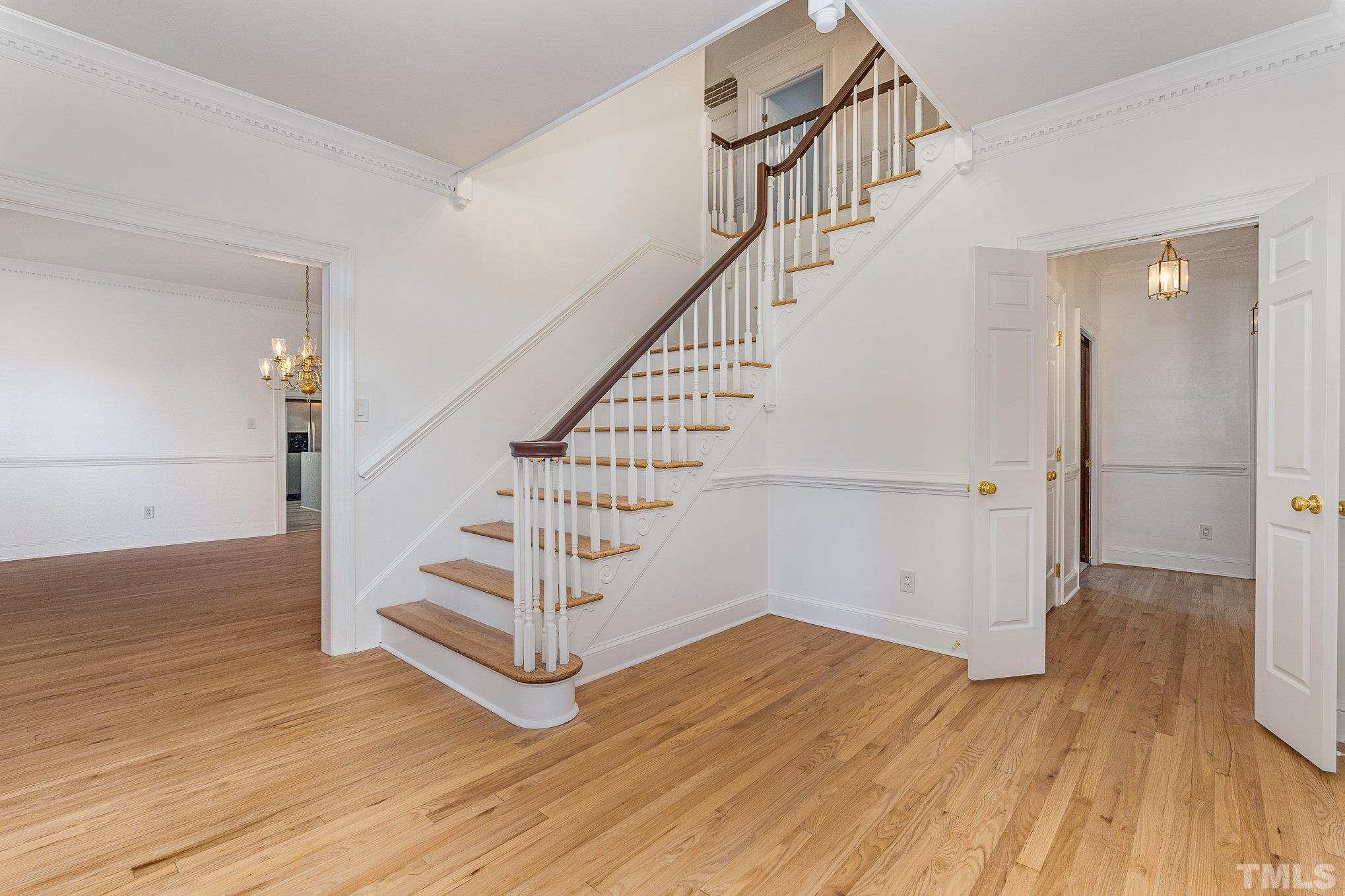 5101 Holly Ridge Farm Road Raleigh, NC 27616 - Photo 3 of 26 a view of entryway with wooden floor and stairs