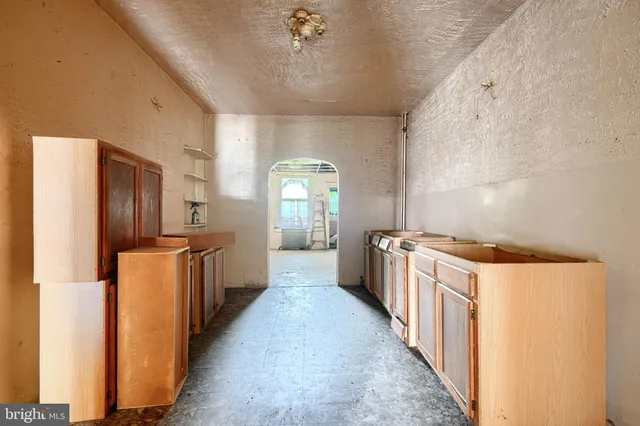 a kitchen with stainless steel appliances a refrigerator a sink dishwasher with a stove and cabinets