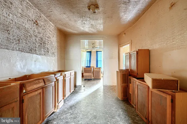 a view of a room with lots of wooden furniture and windows