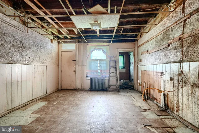 a view of an empty room with wooden walls
