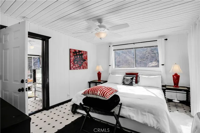 a view of a livingroom with furniture and a floor to ceiling window