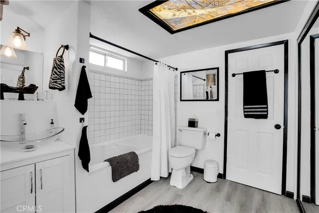 a view of a patio with table and chairs potted plants and floor to ceiling window