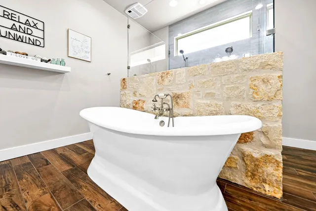 a bathroom with a bathtub and shower